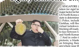  ?? REUTERS ?? Howard, an Australian-Chinese impersonat­ing North Korean leader Kim Jong-un, poses with a durian at the Esplanade in Singapore on Monday.