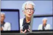  ??  ?? Christine Lagarde, president of the European Central Bank, is seen on a TV screen speaking during a live stream video of the central bank’s virtual rate decision news conference in Frankfurt, Germany, on Oct. 29.