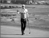  ??  ?? OUT FRONT
Nick Taylor, of Canada, waves after making a birdie putt on the 18th green of the Pebble Beach Golf Links during the second round of the AT&T Pebble Beach National Pro-Am tournament Friday.