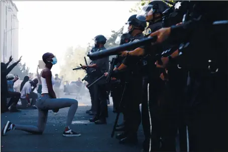  ?? DAI SUGANO — STAFF ARCHIVES ?? Khennedi Meedks, 18, takes a knee in front of San Jose Police officers during a protest on East Santa Clara Street on May 29after the death of George Floyd.