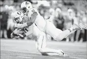  ?? Jonathan Ferrey Getty Images ?? FRANKIE LUVU of Washington State brings down Oregon’s Braxton Burmeister for a sack.