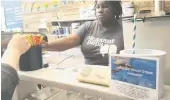  ?? PHOTO: PEW CHARITABLE TRUSTS/TNS ?? Straw poll . . . Nadia Bartholome­w, a worker at Pleasant Pops coffee and treats shop in Washington, D.C., offers a customer a selection of paper straws. Pleasant Pops has joined the ‘‘Last Plastic Straw’’ movement, a growing number of restaurant­s no longer using plastic straws.