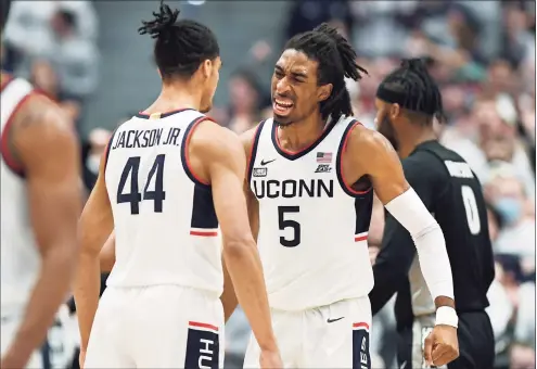  ?? Jessica Hill / Associated Press ?? UConn’s Isaiah Whaley, right, bumps chests with Andre Jackson in the first half against Providence on Saturday.