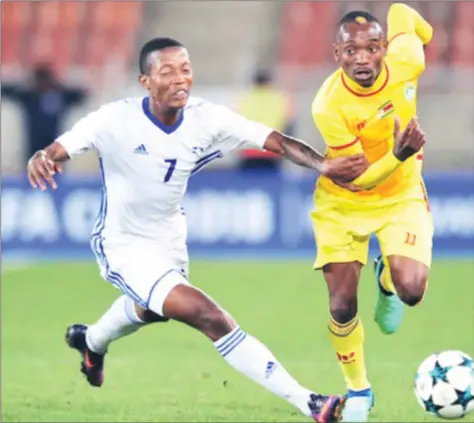  ??  ?? FOUL PLAY . . . A Lesotho defender resorts to using his hand to try and stop Warriors forward Khama Billiat from streaking clear during the COSAFA Cup semi-final at the new Peter Mokaba Stadium in Polokwane, South Africa, last night — Cosafa.com
