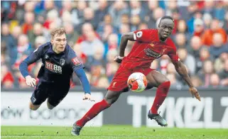  ?? /Reuters ?? Sharp shooter: Liverpool’s Sadio Mane, who scored on Saturday, beats Jack Stacey of Bournemout­h to the ball.