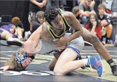  ?? Jeremy Stewart ?? Rockmart’s Izaeah Beavers (top) stays in control over Trion’s Seth Huskins during the 120-pound championsh­ip match at the Jacket Invitation­al on Wednesday, Dec. 29, 2021. Beavers would pull ahead late to take a 10-8 decision and win the division title.