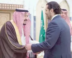  ?? — Reuters ?? Saudi Arabia’s King Salman bin Abdulaziz al Saud shakes with outgoing Lebanese Prime Minister Saad al Hariri during their meeting in Riyadh, Saudi Arabia, on Monday.