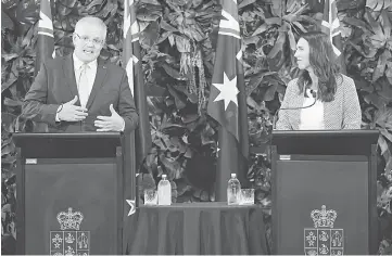  ??  ?? Morrison (left) gestures as he speaks beside Ardern during a joint press conference in Auckland. — AFP photo