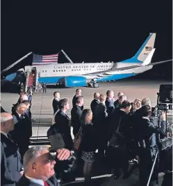  ?? Pictures: AP. ?? President Donald Trump, left, with first lady Melania Trump, watch Secretary of State Mike Pompeo, right, embrace former North Korean detainee Tony Kim, with Kim Hak Song, third left, and Kim Dong Chul, front. Right: Media at the base.