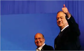  ??  ?? Blue and White party leader Benny Gantz gestures as he stands next to co-leader Moshe Yaalon after exit polls announced in Israel’s election at the party’s headquarte­rs in Tel Aviv, Israel 3 March 2020. Photograph: Corinna Kern/Reuters