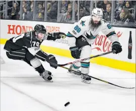  ?? Mark J. Terrill Associated Press ?? A PASS by San Jose Sharks defenseman Brent Burns, right, is just out of the reach of Kings left wing Tanner Pearson at Staples Center.