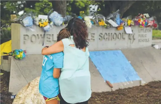  ?? Helen H. Richardson, Denver Post file ?? People pause to reflect at a memorial at Powell Middle School in Littleton set up for a student who recently took his own life.