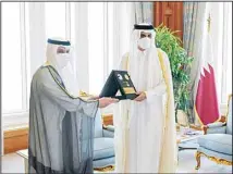  ?? KUNA photo ?? Amir of the State of Qatar receives the Governor of the Central Bank of Kuwait.