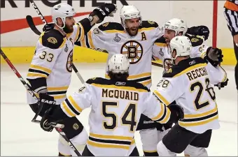  ?? STUART CAHILL - BOSTON HERALD ?? Patrice Bergeron, top center, celebrates his goal with Zdeno Chara (33), defenseman Adam McQuaid (54), Mark Recchi (28) and Brad Marchand as the Bruins take on the Canucks in the first period of Game 7 of the 2011 Stanley Cup Finals in Vancouver.