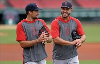  ?? MATT sTONE PHOTOs / HErAld sTAFF ?? THE BOYS ARE BACK IN TOWN: Nathan Eovaldi (left) and Marcus Walden share a laugh as the Red Sox opened summer camp at Fenway Park on Friday.