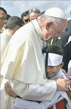  ?? L’Osservator­e Romano via AP ?? Pope Francis greets a child in Yangon, Myanmar on Monday. The pontiff is in Myanmar for the first stage of a weeklong visit that will also take him to neighborin­g Bangladesh.