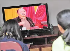  ?? — AFP photo ?? File photo shows Zheng, speaking on television as villagers watch the broadcast in Wukan, Guandong province, where residents demanded the government take action over illegal land grabs and the death in custody of a local leader.