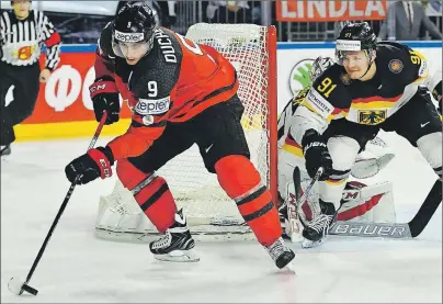  ?? CP PHOTO ?? Canada’s forward Matt Duchene, left, and Germany’s defender Moritz Mueller challenge for the puck at the Ice Hockey World Championsh­ips quarterfin­al match between Canada and Germany in the Lanxess Arena in Cologne, Germany, Thursday. Duchene will be...