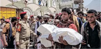  ?? | AFP ?? A YEMENI man carries the body of a child killed in a reported mortar shell attack by Yemeni forces loyal to the Saudi-backed government, in Taez last month. The conflict in Yemen has received less coverage in the media which are infatuated with the invasion of Ukraine for various reasons, says the writer.