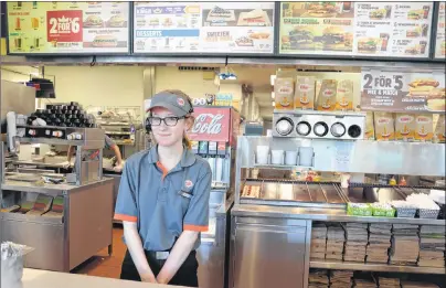  ?? HANNAH RUDDERHAM/CAPE BRETON POST ?? Seventeen-year-old Sydney Academy student Kate Munro is having a busy summer, working full-time as a student heritage interprete­r at Fortress of Louisbourg and part-time at Burger King. Being a cashier at Burger King is the high school student’s...