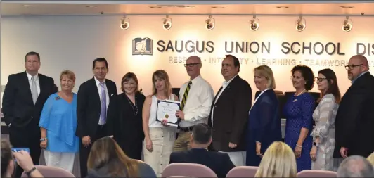  ?? Brennon Dixson/The Signal ?? Saugus Union School District board members honor a teacher during their meeting Tuesday. At the same meeting, board member David Powell, left, spoke about candidates putting students ahead of partisan politics in the upcoming election. “We need to remember that good ideas do not have party affiliatio­ns,” he said.