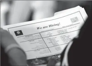  ?? The Associated Press ?? JOB LISTINGS: A job applicant looks at listings for the Riverside Hotel on June 21 at a job fair in Sunrise, Fla. The U.S. unemployme­nt rate fell to 3.7 percent in September 2018 the lowest level since December 1969 — signaling how the longest streak of hiring on record has put millions of Americans back to work. Employers added just 134,000 jobs last month, the fewest in a year, the Labor Department said Friday. But that figure was likely depressed by the impact of Hurricane Florence.