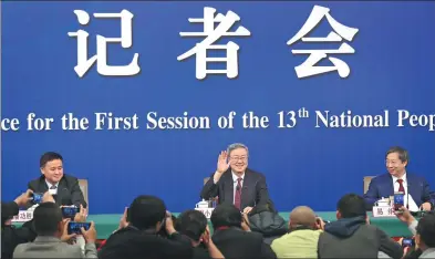  ?? FENG YONGBIN / CHINA DAILY ?? Zhou Xiaochuan (center), governor of the People’s Bank of China, answers reporters’ queries at a news conference on Friday on the sidelines of the first session of the 13th National People’s Congress.