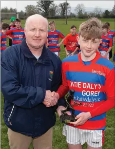  ??  ?? Wicklow Coiste na nÓg Chairman Pat Dunne presents the winning trophy to Luke O’Tooles captain Alex Kavanagh.