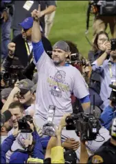  ?? GENE J. PUSKAR/THE ASSOCIATED PRESS ?? Cubs catcher David Ross is carried by teammates after Chicago won the World Series over the Indians with a 10-inning, 8-7 victory in Game 7 on Nov. 3 at Cleveland. Ross has said he is retiring.