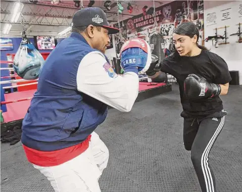  ?? Brian A. Pounds/Hearst Connecticu­t Media file photo ?? Brianna Alers, 16, of Hamden, trains with her coach, Martin Chisholm, at the Chick Rosnick Boxing Club in Stratford in December.