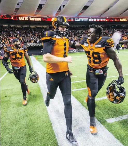  ?? — THE CANADIAN PRESS FILES ?? B.C. Lions kicker Ty Long celebrates with teammate Micah Awe, right, after kicking the winning field goal against the Hamilton Tiger-Cats during the second overtime of Saturday’s game at B.C. Place Stadium.