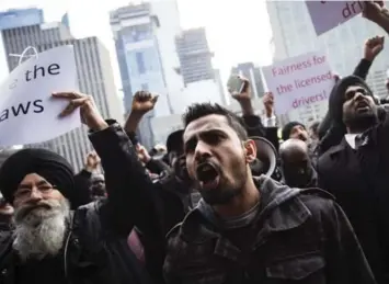  ?? MELISSA RENWICK/TORONTO STAR ?? Taxi drivers held a rally outside city hall, demanding Uber be cast as an “illegal” taxi service.