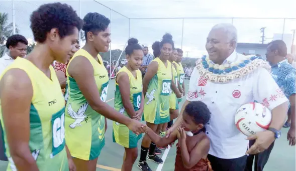  ??  ?? Prime Minister Voreqe Bainimaram­a meets the Tailevu netball team during the opening of the multi-purpose court in Davuilevu, yesterday.