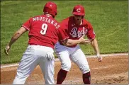  ?? BRYAN WOOLSTON / AP ?? The Cincinnati Reds’ Nick Senzel (right) celebrates with Mike Moustakas after each scored Wednesday against the Pirates in Cincinnati. That day’s 11-4 victory completed a three-game sweep.