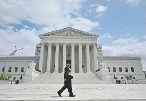  ?? ?? A police officer pitside the US Supreme Court as the court hears arguments on the immunity of former president Donald Trump, below