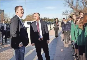  ?? THE OKLAHOMAN FILE ?? Gov. Kevin Stitt, left, and Sen. Greg Treat meet with young people in 2019 after arriving at the Capitol in farm tractors.