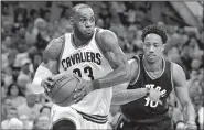  ?? AP/TONY DEJAK ?? Cleveland forward LeBron James (left) scored 35 points and pulled down 10 rebounds in the Cavaliers’ victory over Toronto on Monday night. James has scored at least 32 points in four of Cleveland’s five playoff games so far.