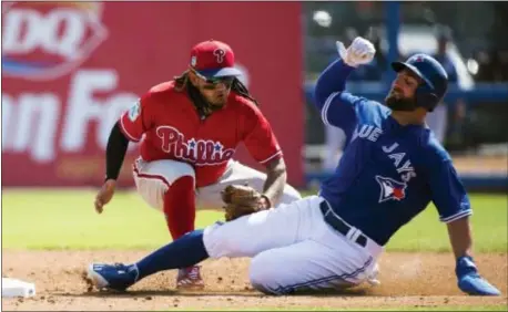 ?? NATHAN DENETTE — THE CANADIAN PRESS VIA AP ?? Phillies shortstop Freddy Galvis last week in Dunedin, Fla. (13) tags out Toronto’s Kevin Pillar (11) at second base on a steal attempt during a game