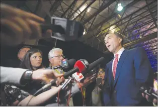  ?? CP PHOTO ?? Finance Minister Bill Morneau speaks with reporters following a meeting at the Assembly of First Nations annual general meeting in Regina. The government posted a thin budgetary surplus of $83 million between April and June, the Finance Department’s...