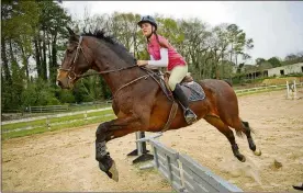  ?? PHILLIPS SPECIAL JONATHAN ?? Kathryn Barclay leads her horse over a jump in the training ring during a lesson with Atlanta In-Town Riding Academy at Little Creek Horse Farm in Decatur on April 3, 2013. The academy teaches students the hunter/jumper style of horseback riding.