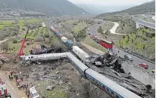  ?? VAGGELIS KOUSIORAS THE ASSOCIATED PRESS ?? Crews work to clean up the aftermath of a collision between a train carrying hundreds of passengers and an oncoming freight train.