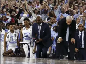  ??  ?? In this April 4 file photo, North Carolina head coach Roy Williams (right) and his players on the bench react after the NCAA Final Four tournament college basketball championsh­ip game against Villanova in Houston. AP PHOTO