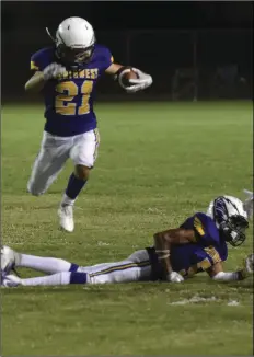  ?? PHOTO AARON BODUS ?? Southwest’s Isaiah Torres (21) leaps over a teammate in the Eagles’ 41-21 home victory over Palo Verde Friday night.