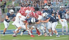  ?? Jan Wright ?? The LFO defense swarms and tries to bring down Gordon Lee running back Brody Cobb. The Trojans moved to 2-0 with a 13-10 win over the Warriors in Chickamaug­a.