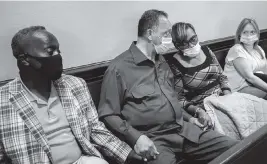  ?? STEPHEN B. MORTON AP ?? The Rev. Jesse Jackson, center, holds hands with Ahmaud Arbery’s parents (Marcus Arbery Sr. and Wanda Cooper-Jones) in court on Monday in Brunswick, Ga.