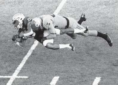  ?? CHANCEY BUSH/AP ?? Air Force linebacker Parker Noren tackles Navy wide receiver Chance Warren during a game on Oct. 3, 2020, at the Air Force Academy in Colorado Springs, Colorado.