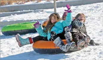  ?? Janelle Jessen/Siloam Sunday ?? Children enjoy sledding in Memorial Park on Thursday. The hill was a popular place for sledding throughout the week.