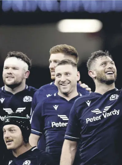  ?? ?? Alec Hepburn and Elliot Millarmill­s lift the Doddie Weir Cup. Above left, Huw Jones and his team-mates were able to evade a stirring Welsh comeback