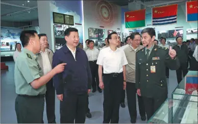  ?? MA ZHANCHENG / XINHUA ?? President Xi Jinping, accompanie­d by Premier Li Keqiang and other leaders, visits the Military Museum of the Chinese People’s Revolution in Beijing on Friday to see an exhibition featuring landmark achievemen­ts of the People's Liberation Army.