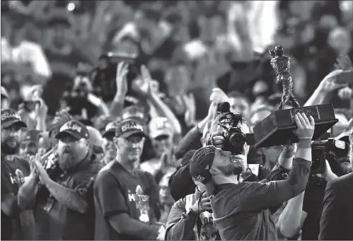  ?? Photo: VCG ?? Boston Red Sox’s Steve Pearce holds the MVP trophy after Game 5 of baseball’s World Series against the Los Angeles Dodgers on Sunday in Los Angeles.